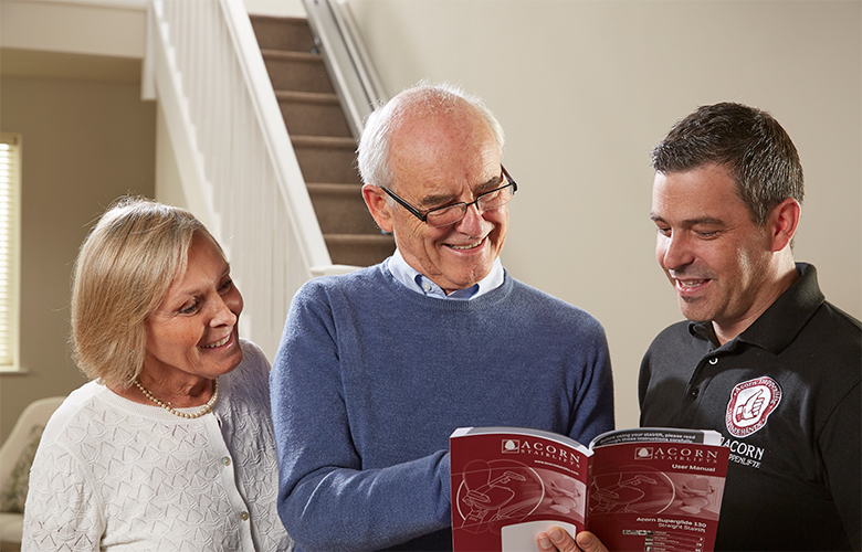 Acorn technician reviewing user manual with customers