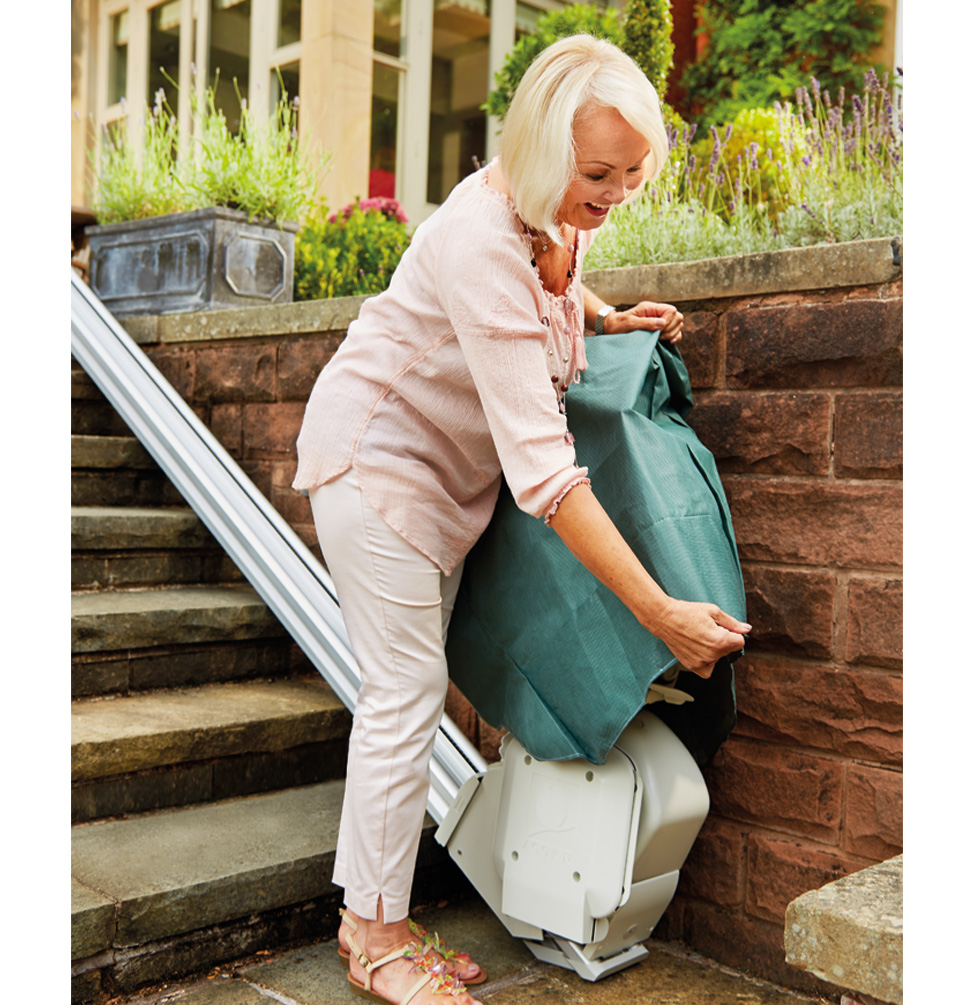 Lady putting outdoor cover over Acorn 130